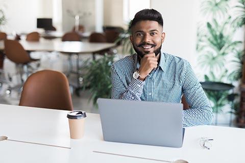 Young man using laptop in public space